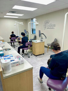 A row of orthodontists seeing to patients