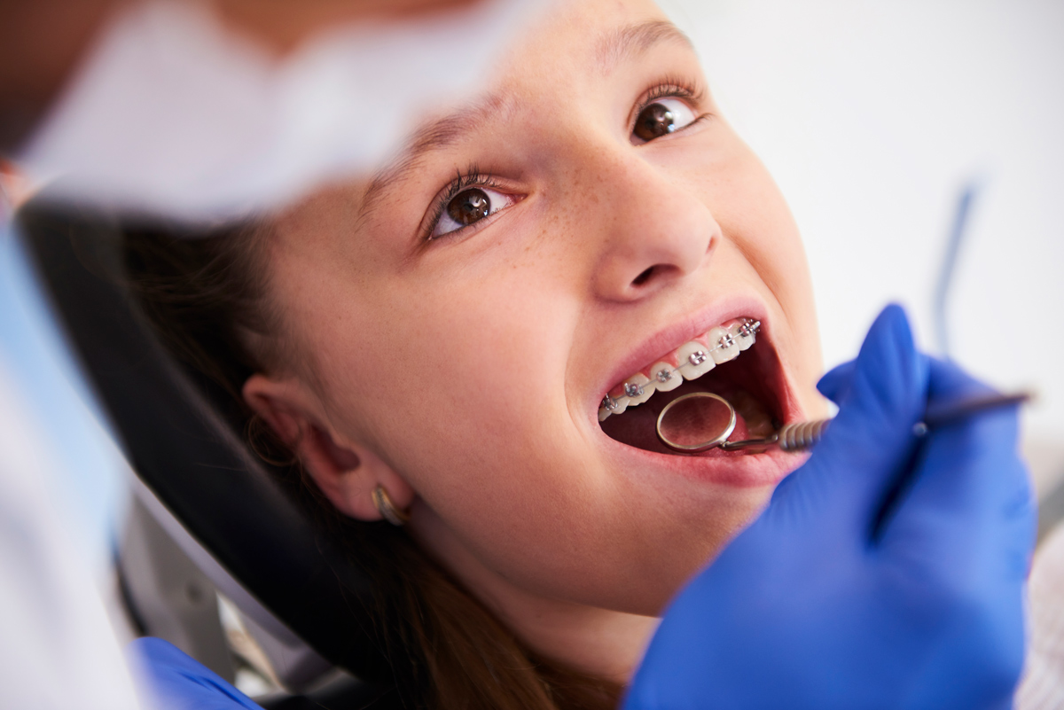 young girl getting braces examined