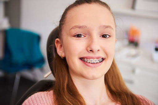 young female patient in othodontic office smiling with braces callan orthodontics braces treatment in lawrenceville nj