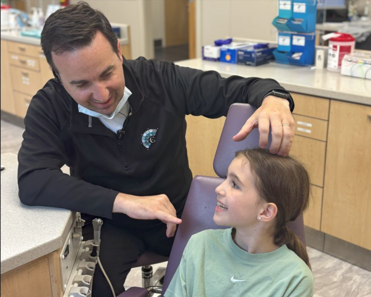 dr callan speaking with a young child patient pediatric orthodontist lawrenceville nj