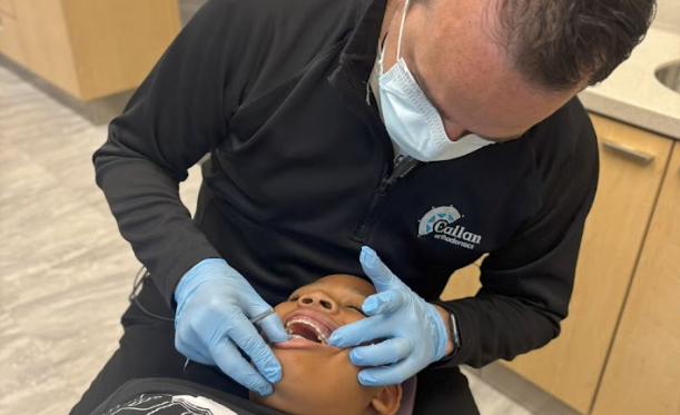 dr callan checking child's partial braces at callan orthodontics in lawrenceville nj pediatric orthodontist in lawrenceville nj