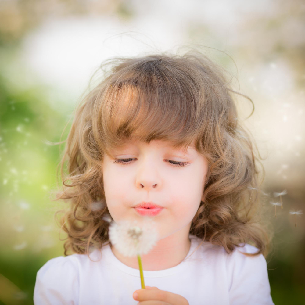 child blowing dandelion outside airway concerns callan orthodontics pediatric orthodontist in lawrenceville nj 